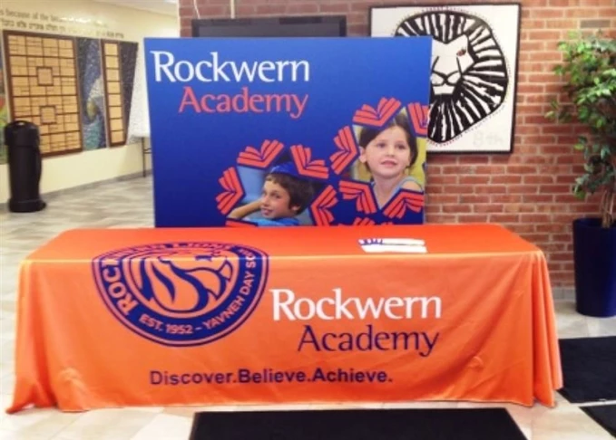 Whether you need an in house display or a display that can hit the road, we have your solution.  (Table throw and display banner by Signs Now Cincinnati for Rockwern Academy, Cincinnati, OH)